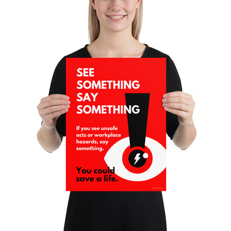 A workplace safety poster with a bright red background an an eye with an exclamation point coming from the pupil and a lightning bolt in the middle of the pupil with text that says "See Something Say Something" in bold lettering with the words "If you see unsafe acts or workplace hazards, say something. You could save a life."