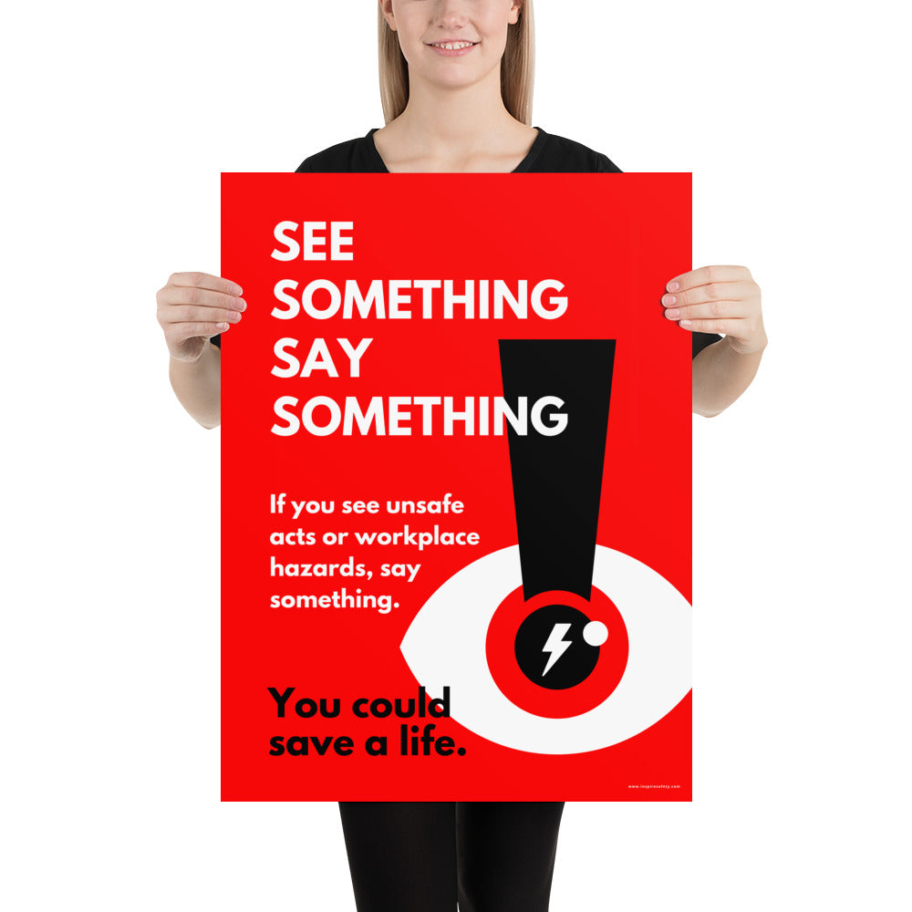 A workplace safety poster with a bright red background an an eye with an exclamation point coming from the pupil and a lightning bolt in the middle of the pupil with text that says "See Something Say Something" in bold lettering with the words "If you see unsafe acts or workplace hazards, say something. You could save a life."