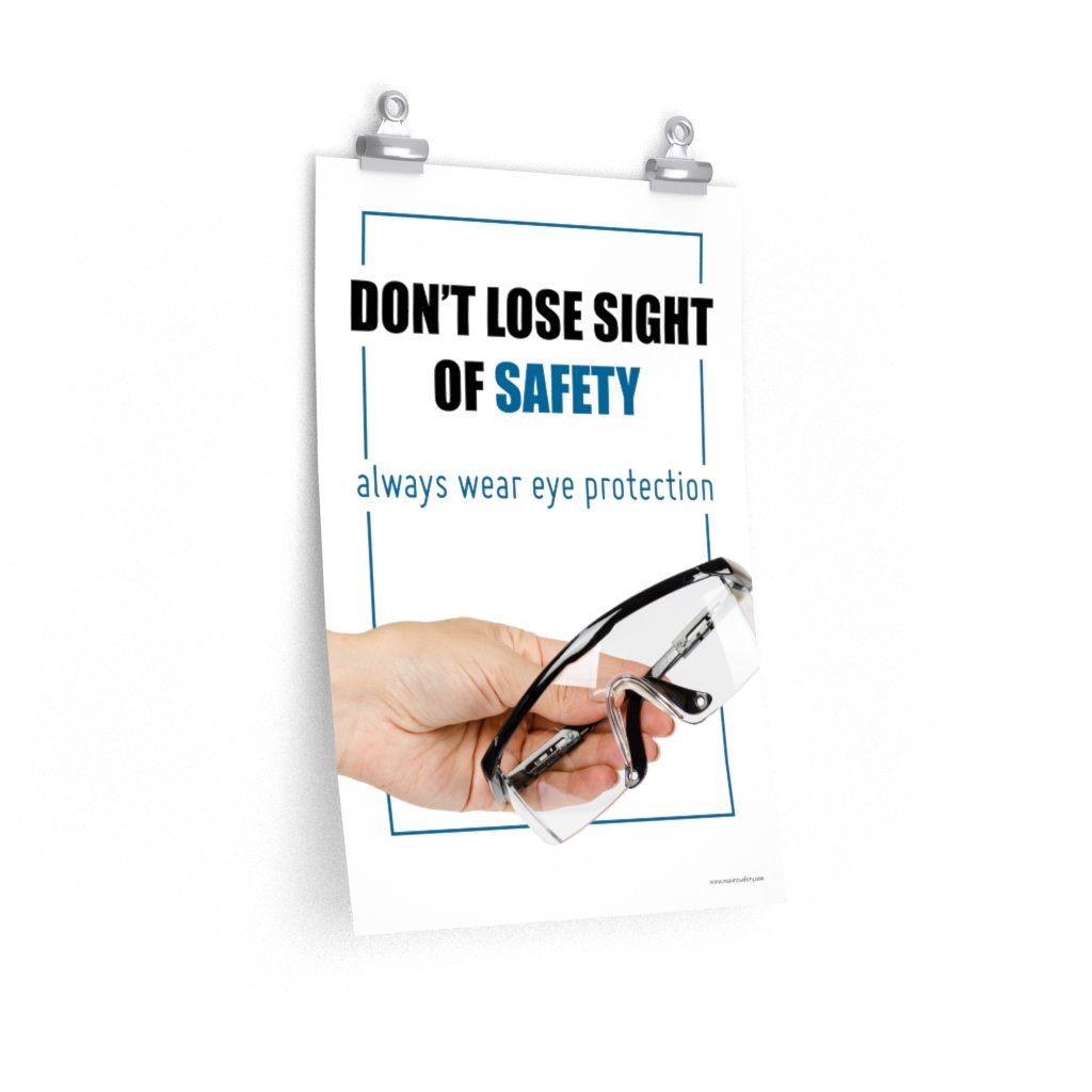 An eye safety slogan showing a close up of a hand presenting out safety glasses with a safety slogan in blue text above.