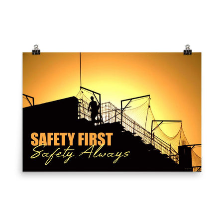 A workplace safety poster showing a construction site and construction workers being silhouetted by a bright and beautiful sunset of different shades of orange with the slogan safety first, safety always.