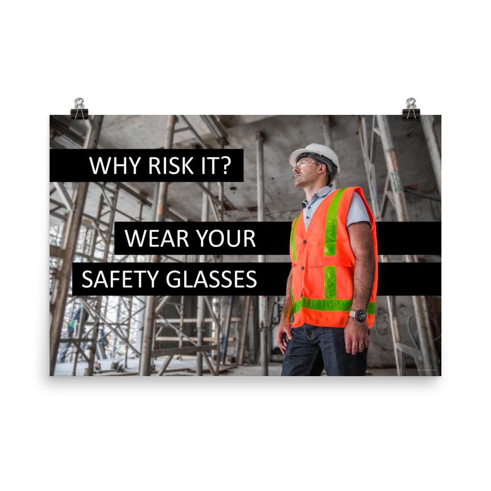 A safety poster showing a construction worker in a reflective orange vest, hard hat, and safety glasses on a construction site looking out with a safety slogan to the left.