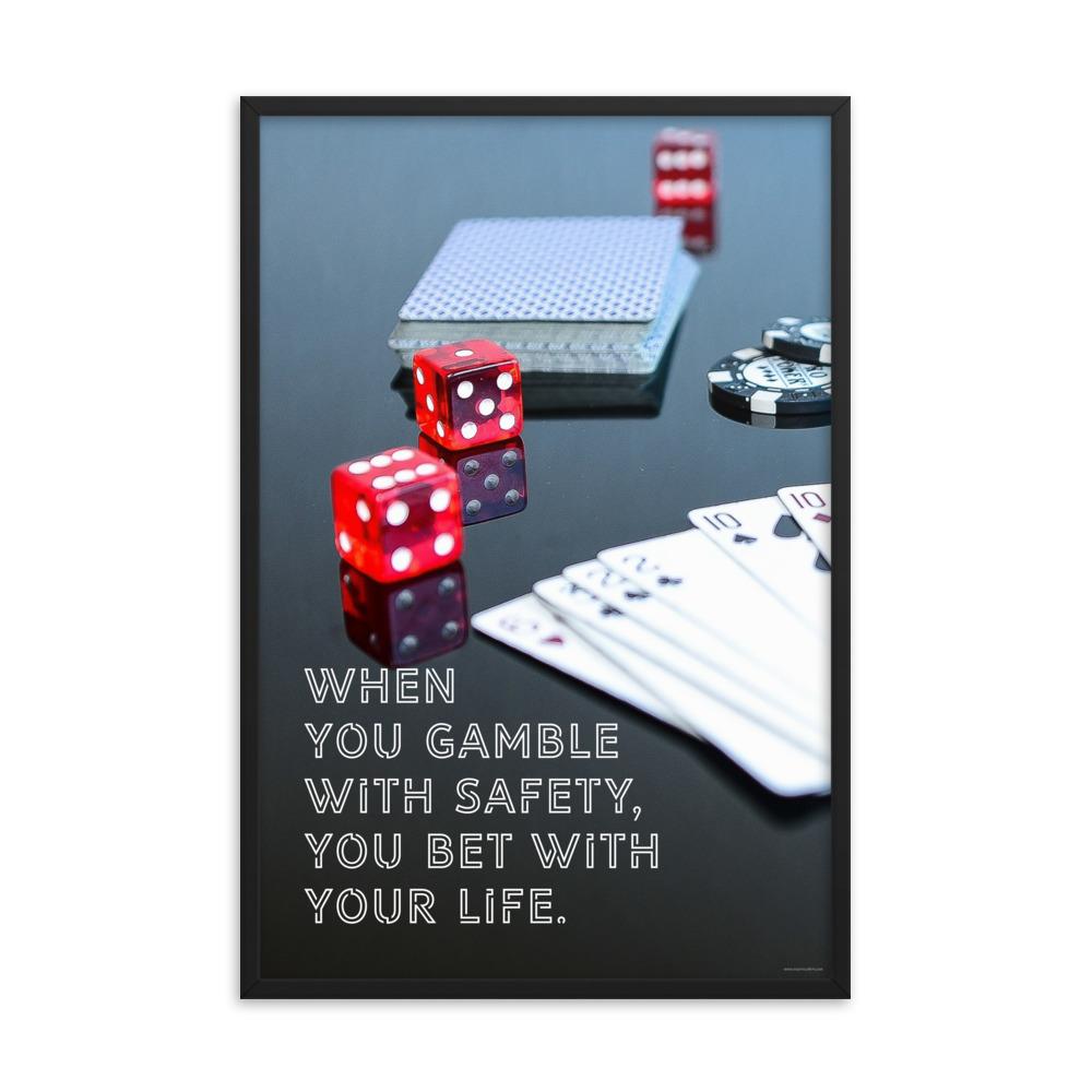 A workplace safety poster of a glossy black table with red dice, playing cards, and poker chips strewn everywhere with a safety slogan in the bottom left corner.