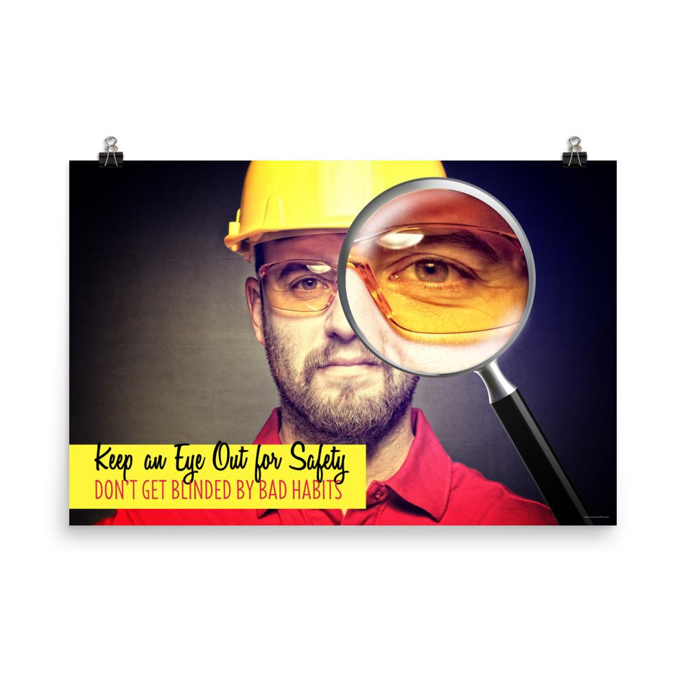 A workplace safety poster showing a portrait of a man wearing a hardhat and safety glasses with a magnifying glass magnifying one eye with the slogan, keep an eye out for safety, don't get blinded by bad habits.