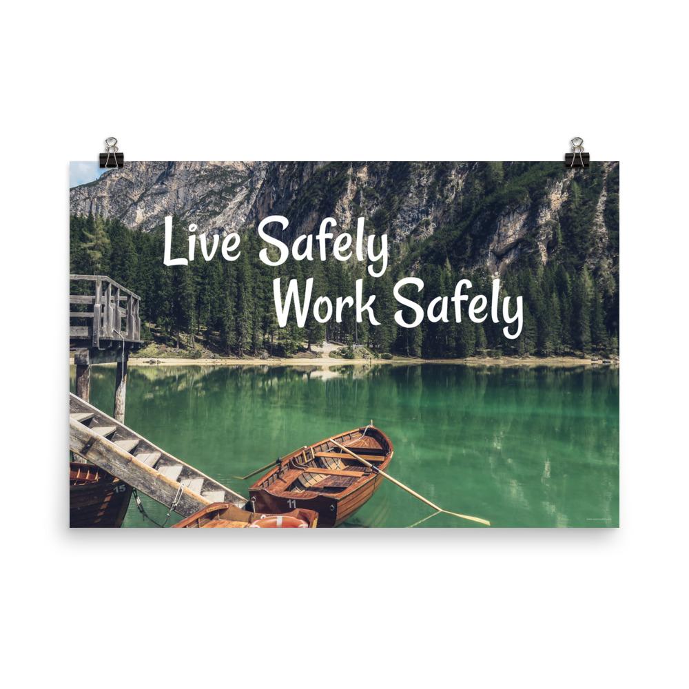 A workplace safety poster depicting a beautiful landscape of mountains in the background of a lake with a little wooden boat in the lake with text saying live safely work safely.