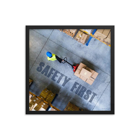 A safety poster showing a bird's-eye view of a worker in a warehouse pulling boxes on a pallet jack with the slogan safety first in bold letters.