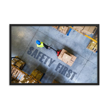 A safety poster showing a bird's-eye view of a worker in a warehouse pulling boxes on a pallet jack with the slogan safety first in bold letters.