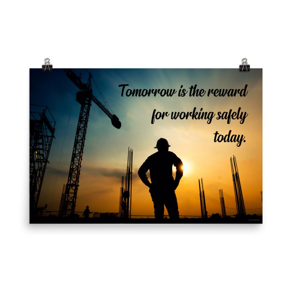 A safety poster showing a worker on a construction site being silhouetted by a sunset of orange and blue colors with the slogan tomorrow is the reward for working safely today.