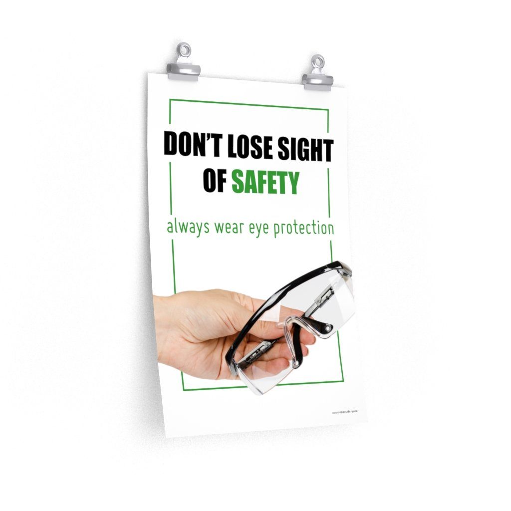 An eye safety slogan showing a close up of a hand presenting out safety glasses with a safety slogan in blue text above.
