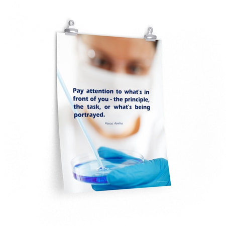 Safety poster showing a close up of a woman's face wearing safety glasses and a white face mask, holding a petri dish and pipette with a safety quote written in blue text.