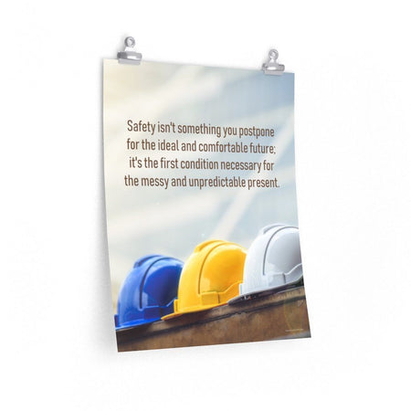 A workplace safety poster showing 3 multi colored hardhats sitting on a wall with the slogan safety isn't something you postpone for the ideal and comfortable future. It's the first condition necessary for the messy and unpredictable present.