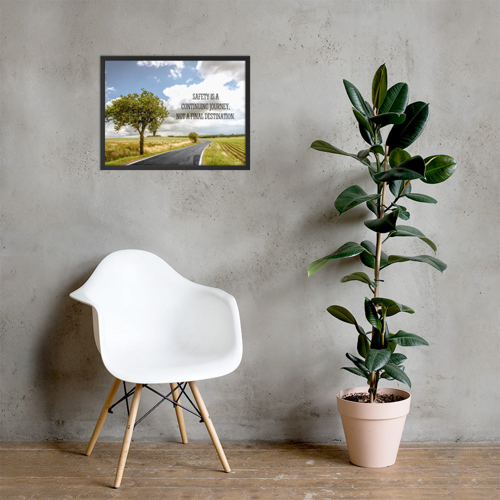 A workplace safety poster depicting a beautiful sunny day with a bright blue sky and a lush green field being cut down the middle by a road leading off into the countryside with the text safety is a continuing journey, not a final destination.
