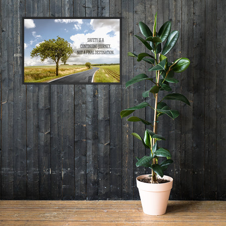 A workplace safety poster depicting a beautiful sunny day with a bright blue sky and a lush green field being cut down the middle by a road leading off into the countryside with the text safety is a continuing journey, not a final destination.