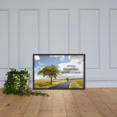 A workplace safety poster depicting a beautiful sunny day with a bright blue sky and a lush green field being cut down the middle by a road leading off into the countryside with the text safety is a continuing journey, not a final destination.