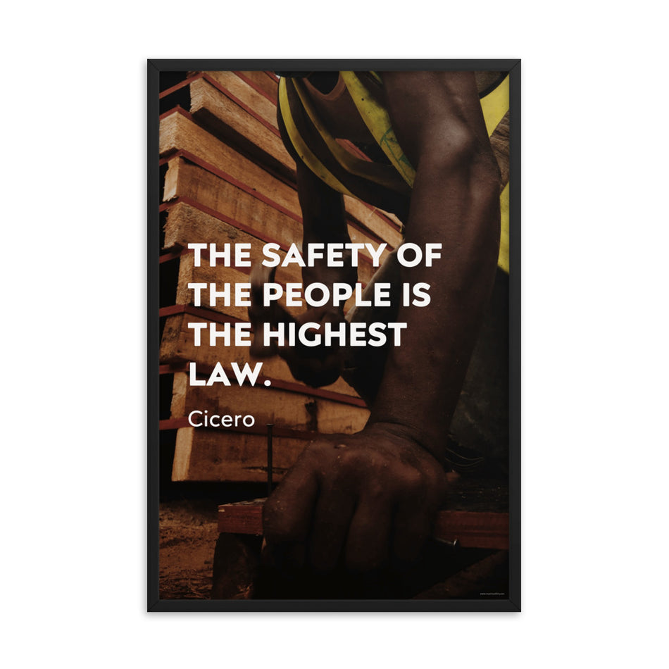 A safety poster of a construction worker in a hi-visibility vest hammering a nail into wood with a safety quote by Cicero that says "The safety of the people is the highest law."