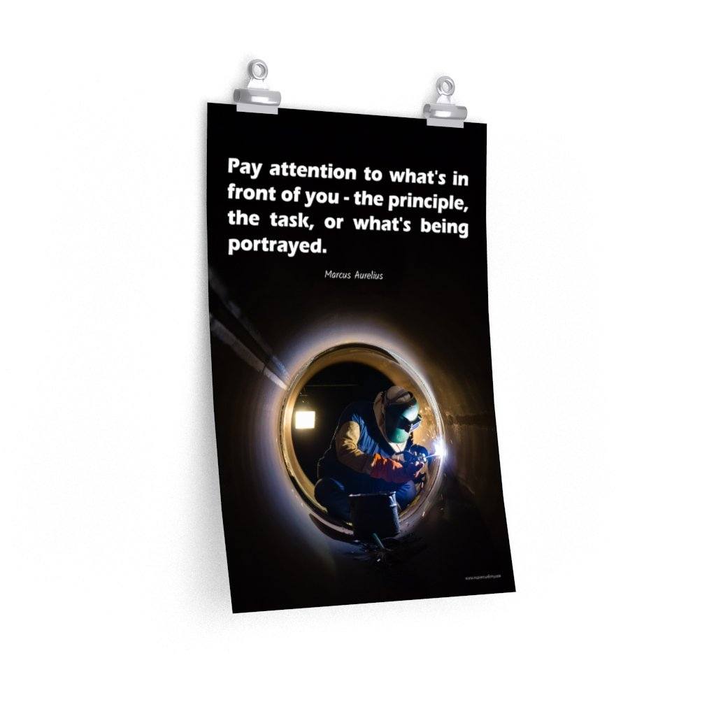 Safety poster of a welder in safety gear and hood sitting inside a large pipe; they are welding with bright sparks flying and a safety quote in white text at the top.