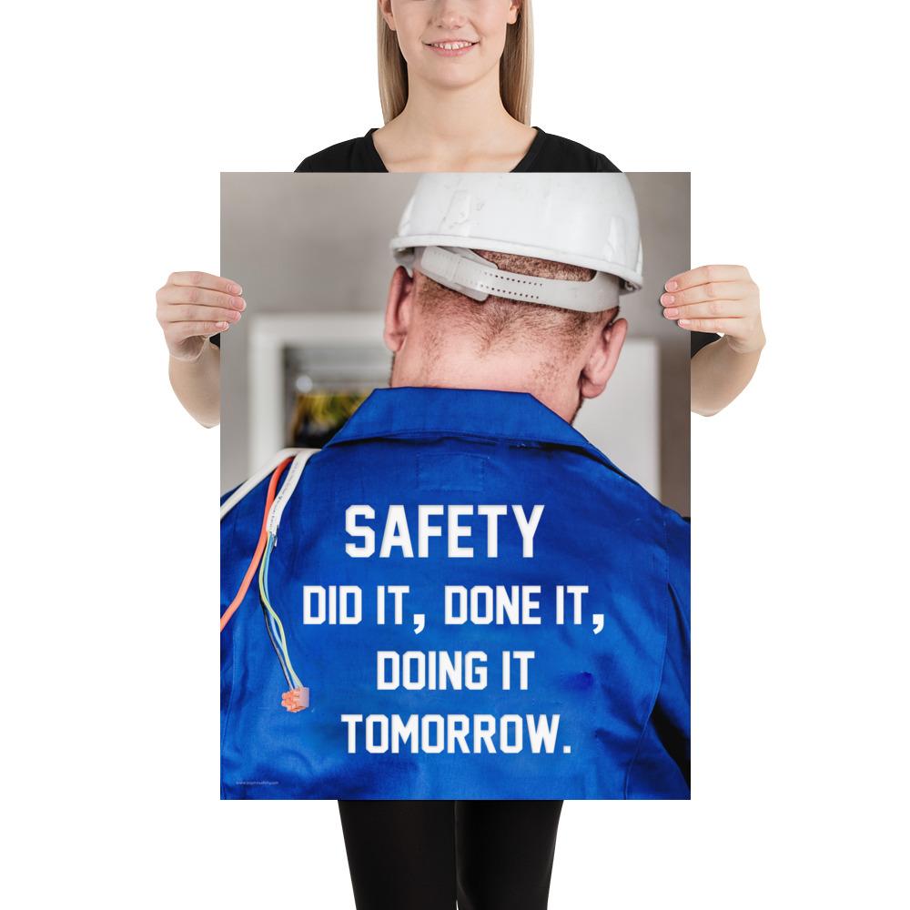 Safety poster showing an electrician wearing a hard hat and holding cables working on an electrical panel with text on the back of his bright blue shirt.