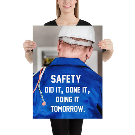 Safety poster showing an electrician wearing a hard hat and holding cables working on an electrical panel with text on the back of his bright blue shirt.