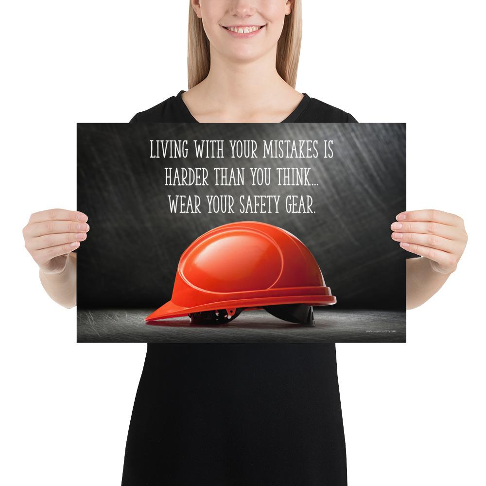 A workplace safety poster showing a bright red hard hat with an ominous black background with the slogan living with your mistakes is harder than you think, wear your safety gear.