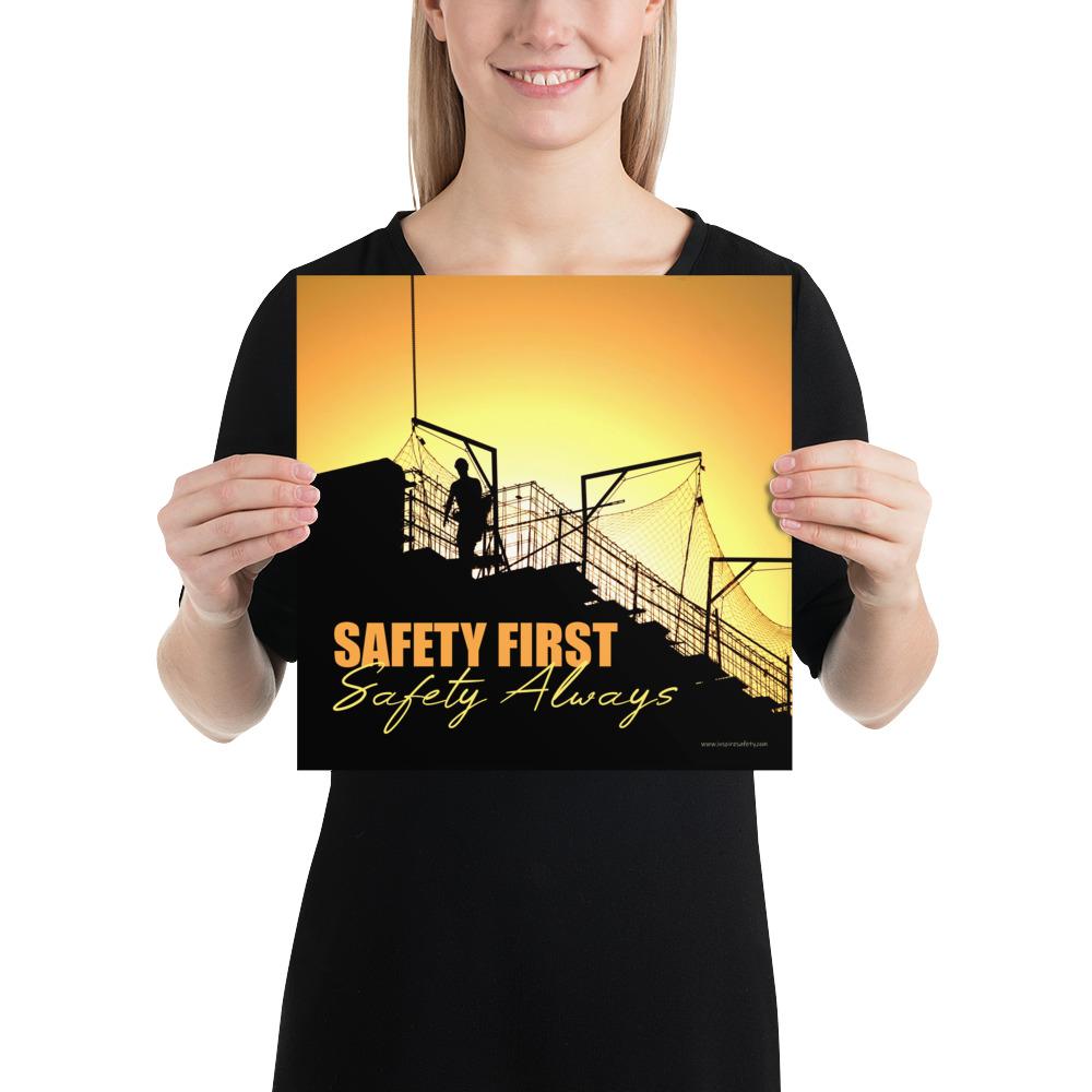 A workplace safety poster showing a construction site and construction workers being silhouetted by a bright and beautiful sunset of different shades of orange with the slogan safety first, safety always.