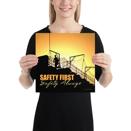 A workplace safety poster showing a construction site and construction workers being silhouetted by a bright and beautiful sunset of different shades of orange with the slogan safety first, safety always.