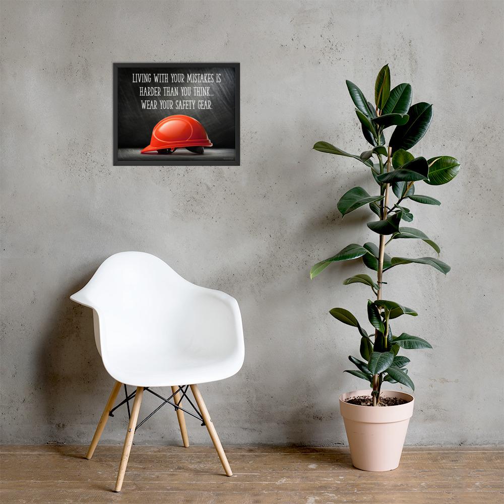 A workplace safety poster showing a bright red hard hat with an ominous black background with the slogan living with your mistakes is harder than you think, wear your safety gear.