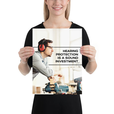 A workplace safety poster of a man in safety glasses and earmuffs taking a break in his woodshop with a safety slogan to the right.