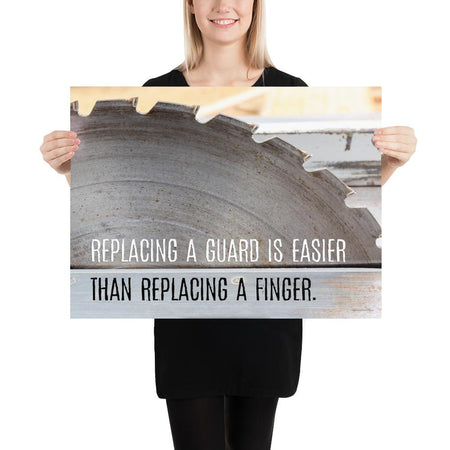 A workplace safety poster depicting a close up of a table saw blade in a workshop with a safety slogan on the bottom half of poster.