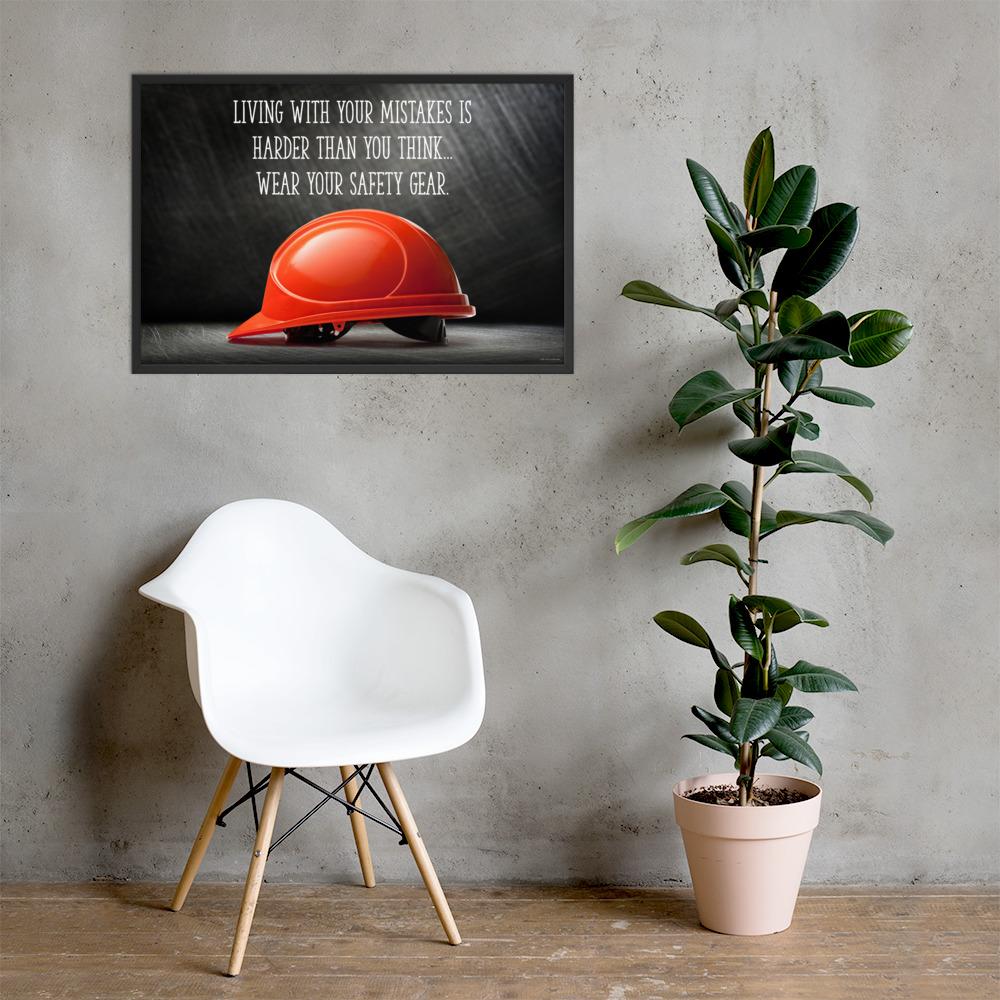 A workplace safety poster showing a bright red hard hat with an ominous black background with the slogan living with your mistakes is harder than you think, wear your safety gear.