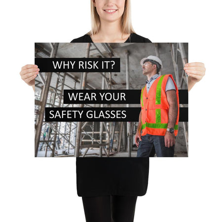 A safety poster showing a construction worker in a reflective orange vest, hard hat, and safety glasses on a construction site looking out with a safety slogan to the left.