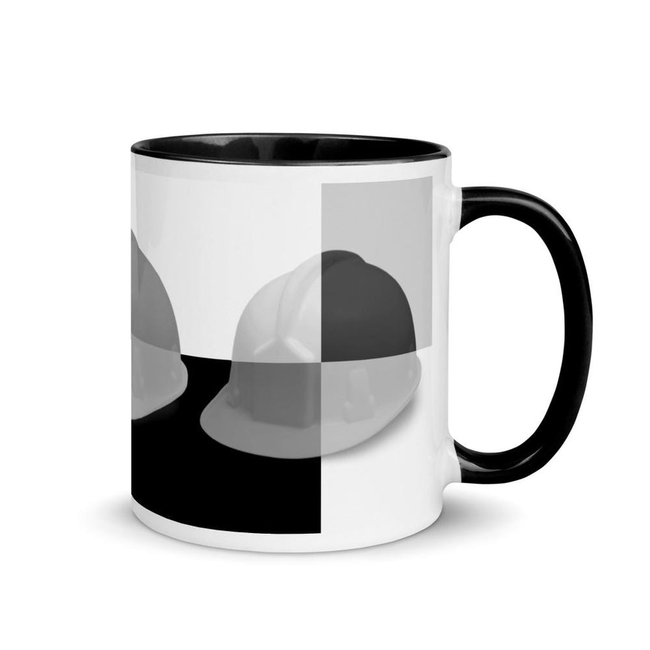 White ceramic mug with a bold hard hat pop art print in a black and grey colorway with black color on the inside, the rim, and the handle.