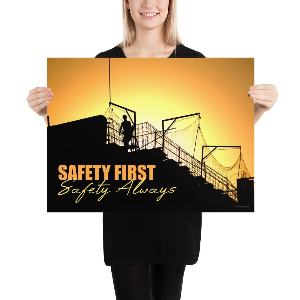 A workplace safety poster showing a construction site and construction workers being silhouetted by a bright and beautiful sunset of different shades of orange with the slogan safety first, safety always.