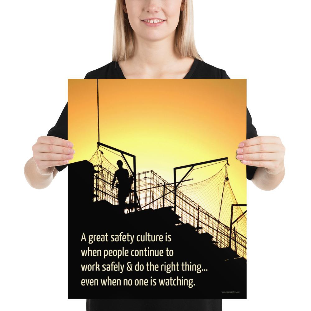 A construction safety poster showing the silhouette of a construction worker working on a building with a bright yellow sunset in the background and a safety slogan in the bottom left corner.