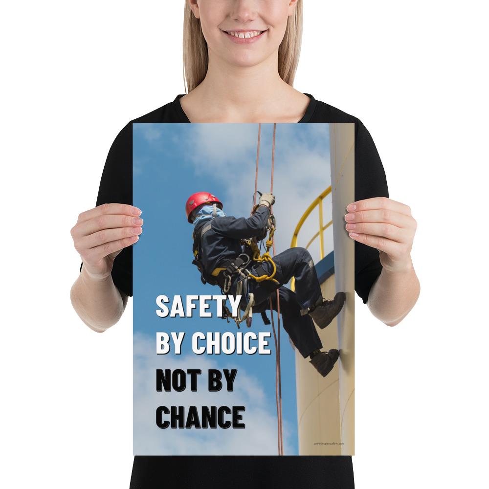A fully harnessed man wearing a hard hat scaling the side of a building with a bright blue sky and clouds in the background with the text safety by choice, not by chance in bold text to his left.