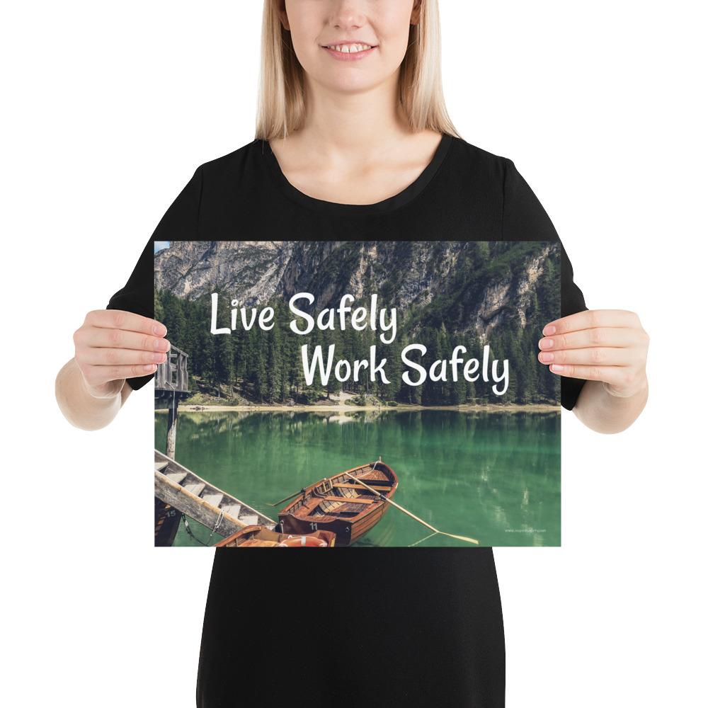 A workplace safety poster depicting a beautiful landscape of mountains in the background of a lake with a little wooden boat in the lake with text saying live safely work safely.
