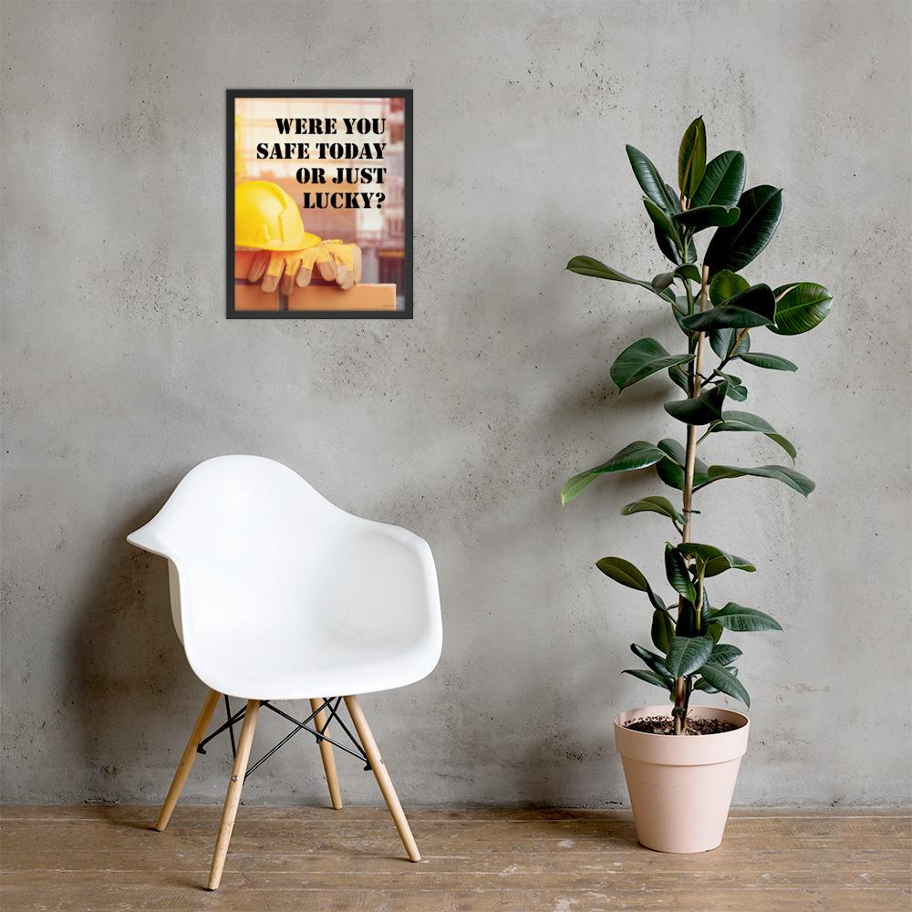 A workplace safety poster showing a yellow hard hat and some gloves sitting on a brick wall on a construction site with the slogan were you safe today, or just lucky written in black stencil font.