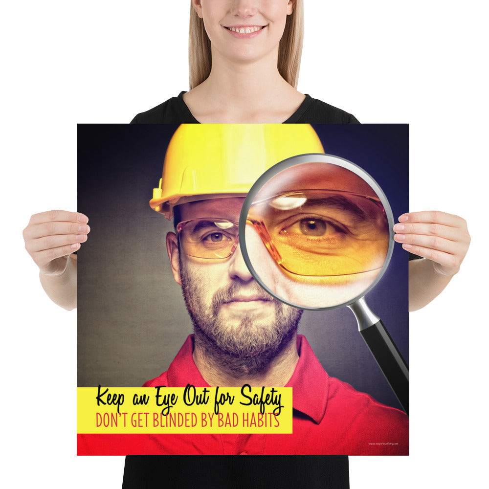 A workplace safety poster showing a portrait of a man wearing a hardhat and safety glasses with a magnifying glass magnifying one eye with the slogan, keep an eye out for safety, don't get blinded by bad habits.