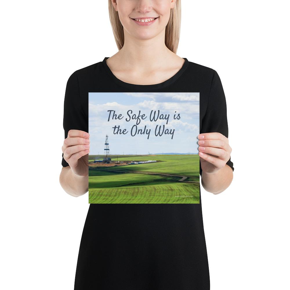 A safety poster showing an oil rig in a beautiful landscape scene of a field with vivid green grass and a bright blue sky with the slogan the safe way is the only way.