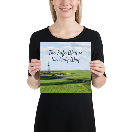 A safety poster showing an oil rig in a beautiful landscape scene of a field with vivid green grass and a bright blue sky with the slogan the safe way is the only way.