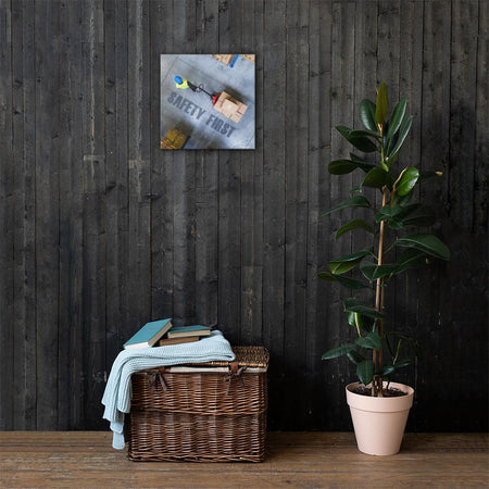 A safety poster showing a bird's-eye view of a worker in a warehouse pulling boxes on a pallet jack with the slogan safety first in bold letters.