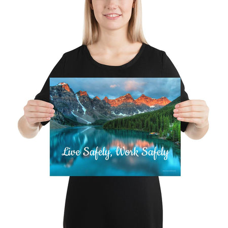 A workplace safety poster depicting a beautiful landscape of mountains with a river flowing down the side of the mountains into a bright blue pond with text saying live safely work safely.