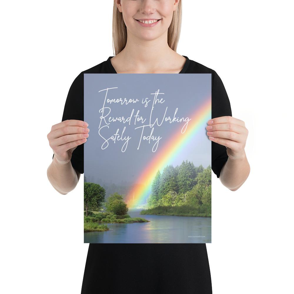 A workplace safety poster showing bright forest scene with a lake and vibrant green trees and a colorful rainbow coming out of the forest with the slogan tomorrow is the reward for working safely today.