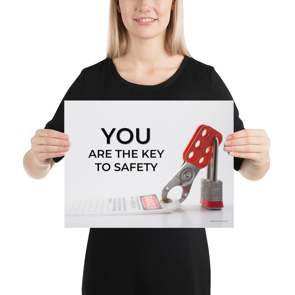 A workplace safety poster showing a lockout tagout lock and tag with the text you are the key to safety.