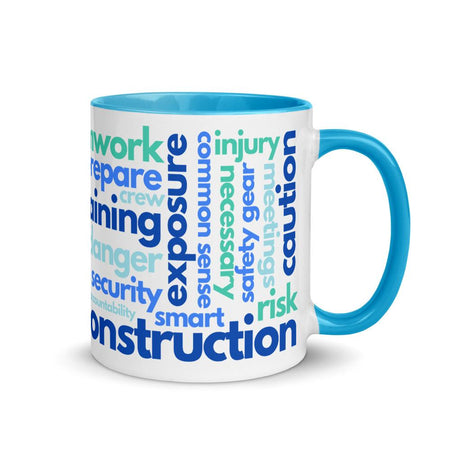 White ceramic mug with safety terms like hard hats, protection, and encourage, in a various shades of blue across the mug with a blue rim, inside, and handle.
