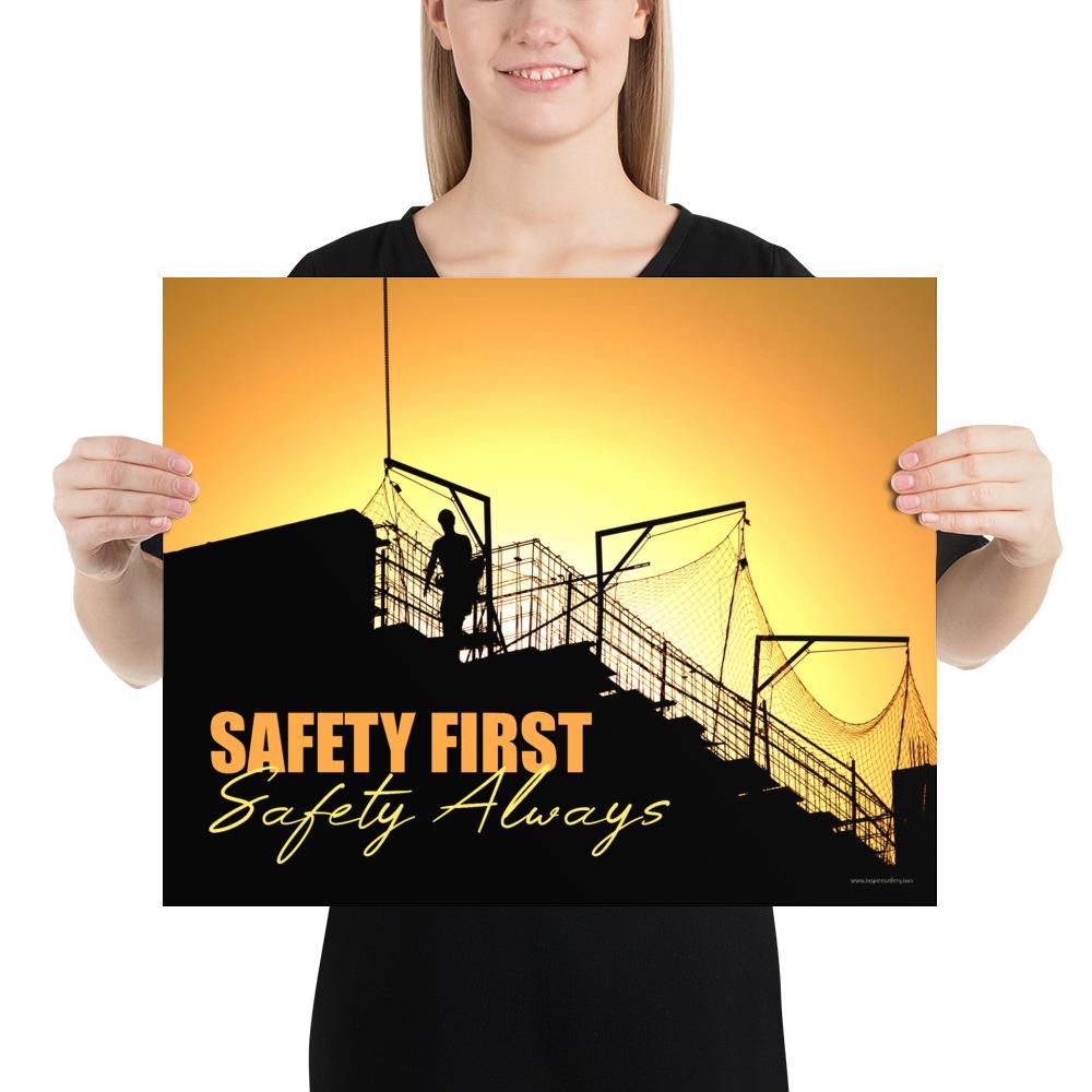A workplace safety poster showing a construction site and construction workers being silhouetted by a bright and beautiful sunset of different shades of orange with the slogan safety first, safety always.