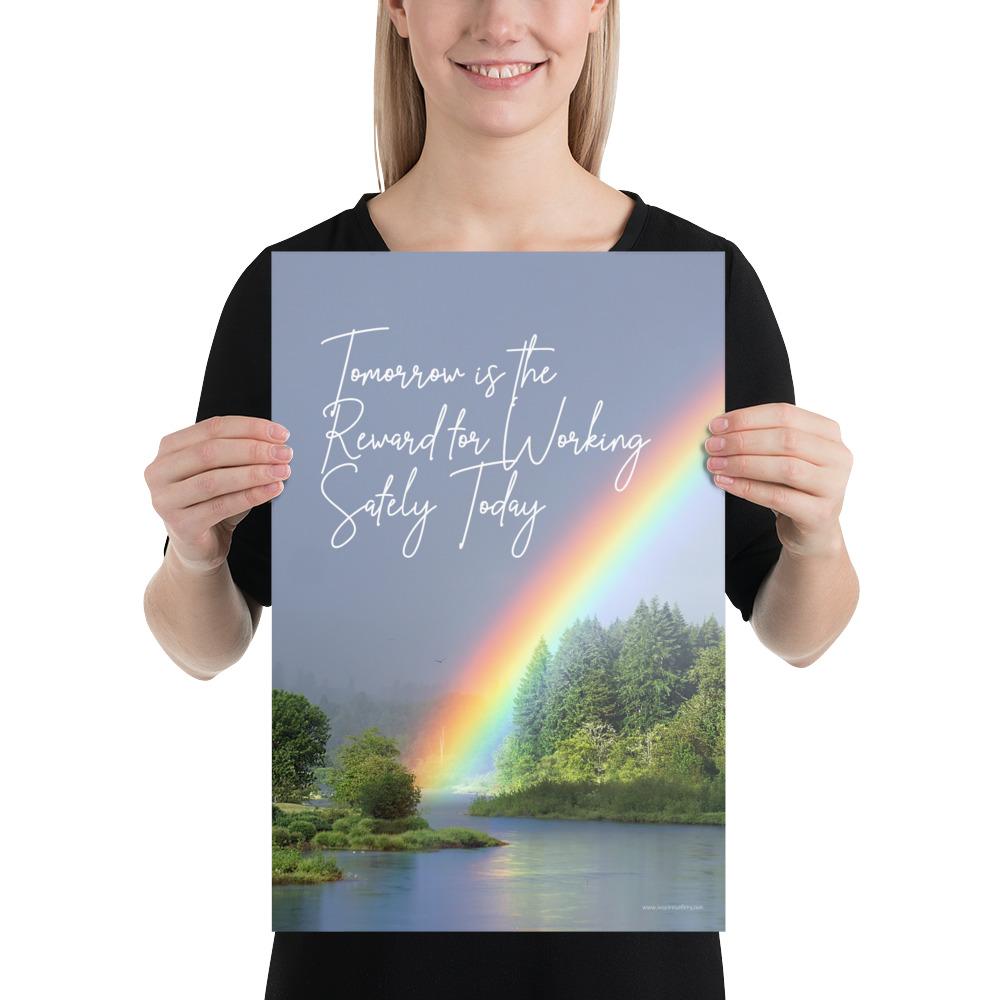 A workplace safety poster showing bright forest scene with a lake and vibrant green trees and a colorful rainbow coming out of the forest with the slogan tomorrow is the reward for working safely today.
