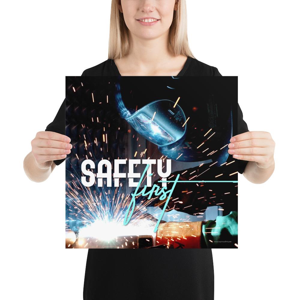 A safety poster showing a close-up of a welder welding a pipe while wearing a welding hood with bright sparks flying all around with the slogan safety first.