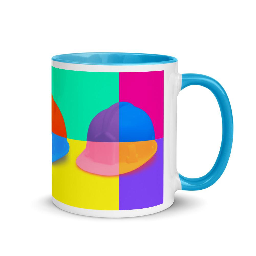 White ceramic mug with a bold hard hat pop art print with blue color on the inside, the rim, and the handle.