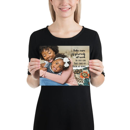 A safety poster showing a mother holding and playing with her young daughter at home with the slogan take care of yourself at work so you can take care of them at home.