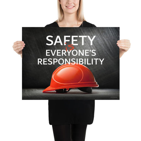 A workplace safety poster showing a red hard hat in front of a grey, industrial-looking background with the slogan safety is everyone's responsibility.