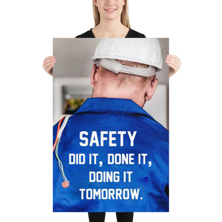 Safety poster showing an electrician wearing a hard hat and holding cables working on an electrical panel with text on the back of his bright blue shirt.